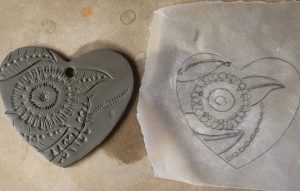 Imprinting a design in order to decorate a Pottery Heart