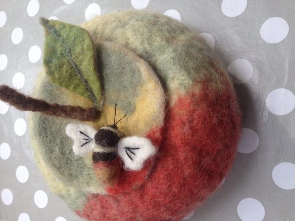 Needle felted bee brooch on a felted apple