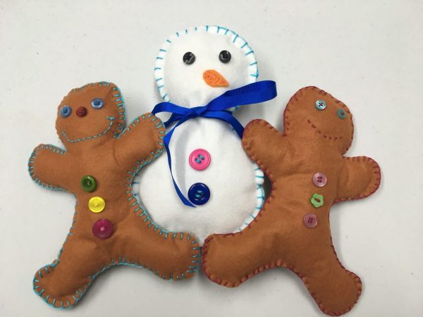 hand sewing kids gingerbread men and snowman